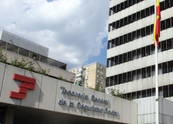 Edificio de la Tesorería General de la Seguridad Social en España con fachada institucional y bandera española.