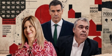 La investigación de la UCO apunta a Pedro Sánchez. Retrato de un hombre con gafas y traje delante de una bandera con franjas rojas y amarillas.