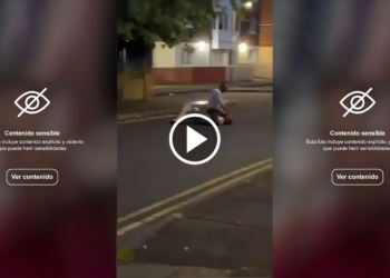 Salvaje intento de decapitación en Belfast: video sensible. Captura de pantalla de un video con advertencia de contenido sensible. Escena nocturna en la calle con una persona en el suelo.