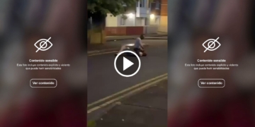 Salvaje intento de decapitación en Belfast: video sensible. Captura de pantalla de un video con advertencia de contenido sensible. Escena nocturna en la calle con una persona en el suelo.