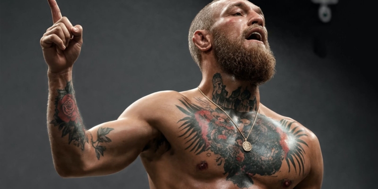 ¡Conor McGregor estalla! Exige expulsiones tras brutal intento de degollamiento en Belfast. Conor McGregor sin camiseta, con el torso tatuado, levantando el dedo índice mientras grita.